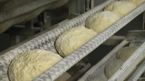 Automated production of bread. The bread dough is formed by baking Stock Footage 61074025