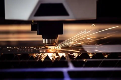 Automated programmed machine. Industrial laser machine cuts out parts in shee Stock Photos