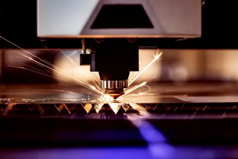 Automated programmed machine. Industrial laser machine cuts out parts in shee Stock Photos