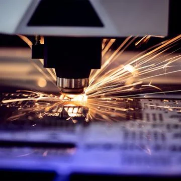 Automated programmed machine. Industrial laser machine cuts out parts in shee Stock Photos