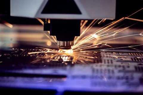 Automated programmed machine. Industrial laser machine cuts out parts in shee Stock Photos