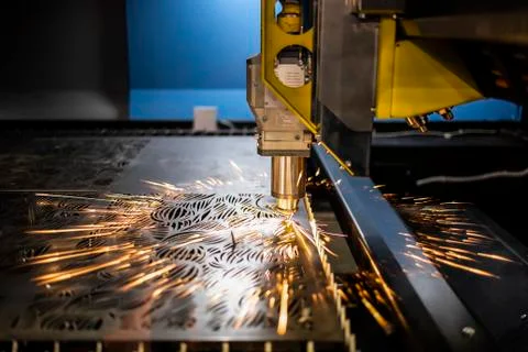 Automated programmed machine. Industrial laser machine cuts out parts in shee Stock Photos