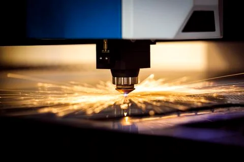 Automated programmed machine. Industrial laser machine cuts out parts in shee Stock Photos