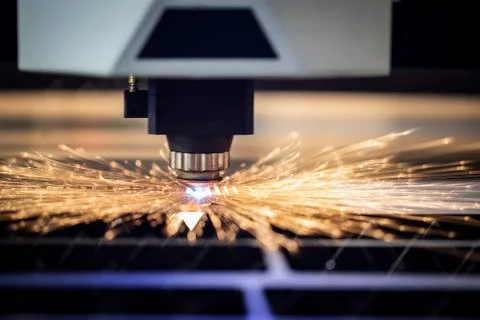 Automated programmed machine. Industrial laser machine cuts out parts in shee Fotos Stock