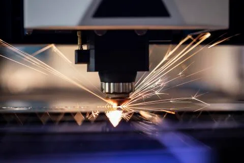 Automated programmed machine. Industrial laser machine cuts out parts in shee Stock Photos