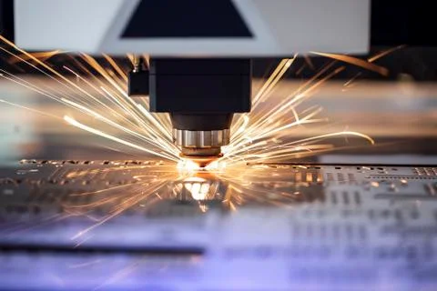 Automated programmed machine. Industrial laser machine cuts out parts in shee Stock Photos