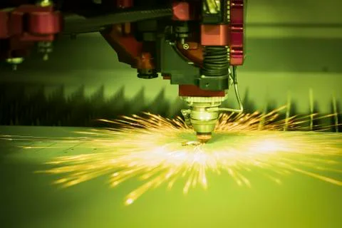 Automated programmed machine. Industrial laser machine cuts out parts in shee Stock Photos