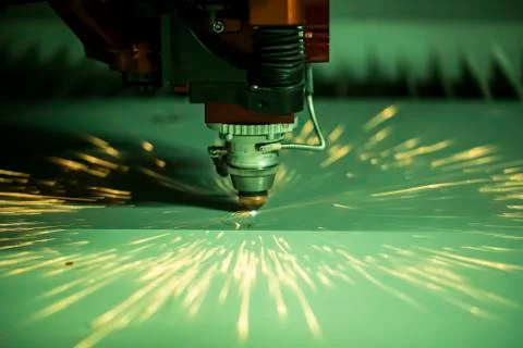 Automated programmed machine. Industrial laser machine cuts out parts in shee Stock Photos