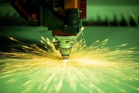 Automated programmed machine. Industrial laser machine cuts out parts in shee Stock Photos