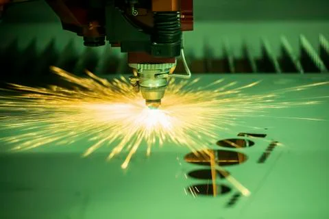 Automated programmed machine. Industrial laser machine cuts out parts in shee Fotos Stock