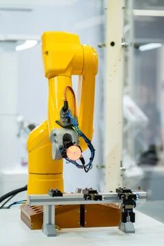 Automated programmed robotic arm for manufacturing and industrial lines conveyor Stock Photos