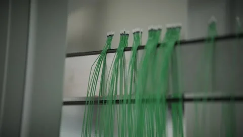 Automated robot hangs finished temperature sensor wires onto a storage rack Stock Footage 328830086