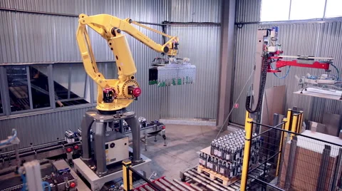 Automated Robotic Arm Loading and assembling products Stock Footage 64737529