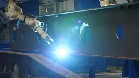 Automated robotic arm performs precise welding on metal beam in modern factory. Stock Footage 313815314
