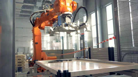 Automated robotic arm works in a factory floor. Stock Footage