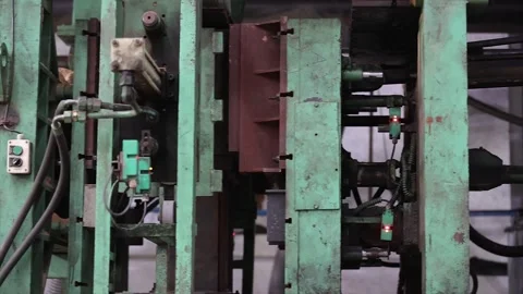 Automated sand casting machine operating inside an industrial foundry Stock Footage 321724674