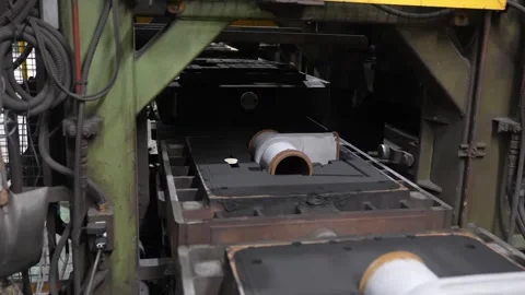 Automated sand casting molding line with ceramic pipe cores moving through Stock Footage 336682256