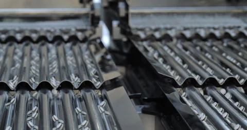 Automated sorting machine guides tablets through corrugated metal channels. Stock Footage 346229495