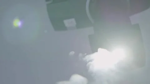 Automated Stage Spotlight Illuminates and Emits Fog in Studio Environment Stock Footage 334541825