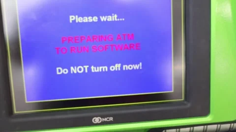 Automated teller machine NCR with text Preparing ATM to run software, text Video stock 276359058