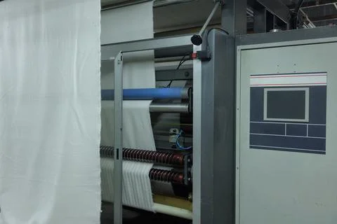 Automated Textile Manufacturing Machine Processing Fabric in Modern Industr.. Stock Photos