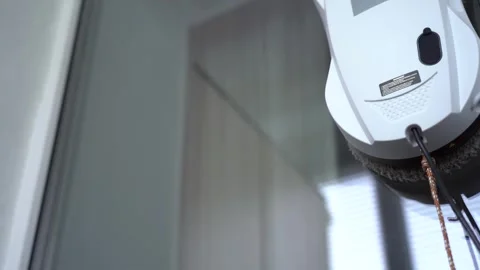 Automated Window Cleaning Robot in Action: Effortlessly Removing Dirt and Grime Stock Footage 333514378