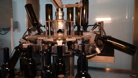 Automated Wine Bottling Machine Filling Dark Glass Bottles Stock Footage 323189341