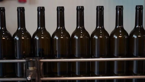 Automated Wine Bottling Process: Glass Bottles Moving on Factory Production Line Stock Footage 323189338