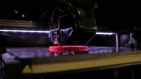 Automatic 3D printer machine printing red flat plastic model: close up Stock Footage 153796526