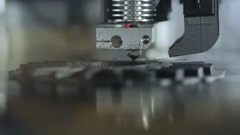 Automatic 3D printer machine printing black flat plastic model: close up Stock Footage 158644477