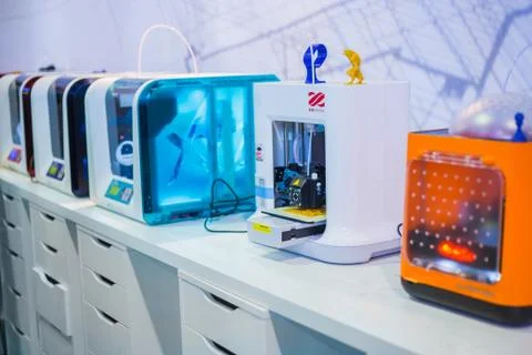 Automatic 3D printers working at modern technology exhibition Stock Photos