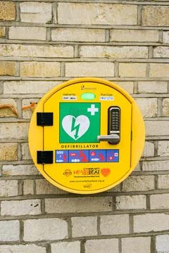 Automatic AED defibrillator on the wall of a shop in a small town Stock Photos