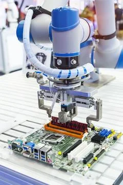 Automatic arm installing a computer chip with ram Stock Photos