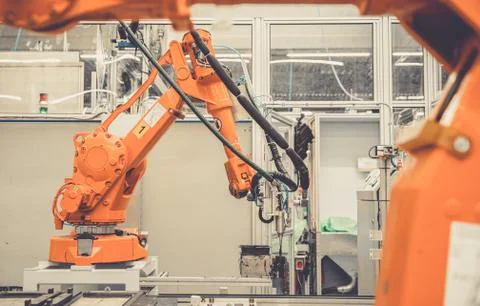 Automatic arms in the factory stopped because of slowing the economy and stop Stock Photos
