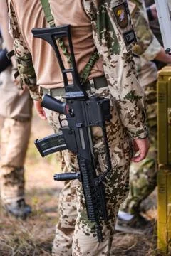 Automatic assault rifle on back of soldier Stock Photos