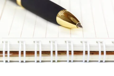 Automatic ballpoint pen and notepad on white background. Stock Photos