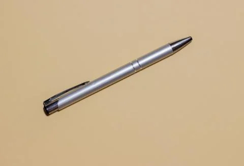 Automatic ballpoint pen on yellow background. Stock Photos