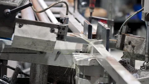 Automatic band saw machine cutting the metal rod with water base coolant method. Stock Footage 269642620