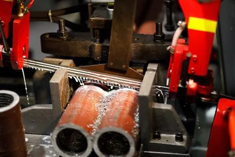 Automatic band saw machine cutting metal pipes Stock Photos