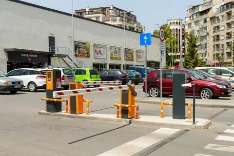 Automatic barrier gate with CCTV camera on the parking lot at the supermarket Stock Photos