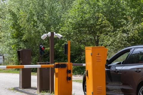 Automatic barrier gate with video surveillance system and red traffic light.. Stock Photos