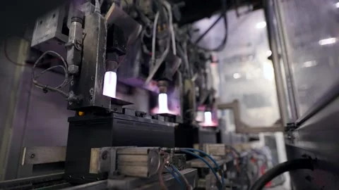 Automatic battery production line. The burner fuses the battery terminals. Stock Footage 147118428
