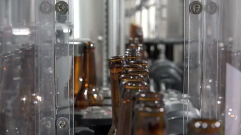 Automatic Beer Bottling Line. Queue of bottles on the conveyor line Stock Footage 238997583