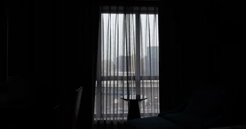 Automatic blackout curtains closing and opening in a dark hotel room Video stock 327653103