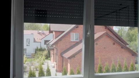 Automatic blinds rising over window in room Stock Footage 334672739