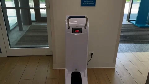 Automatic booties machine in a public area with a digital display for hygie.. Stock Footage 342344992