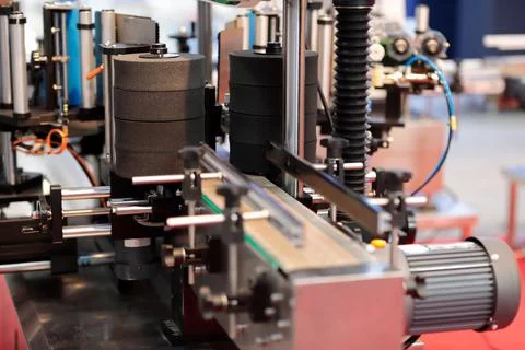 Automatic bottle labeling machine close up Stock Photos