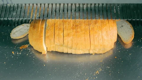 Automatic bread slicer. Slicing bread at the bakery Stock Footage 248829764