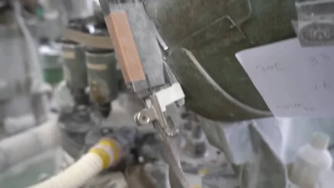 Automatic button carving machine with a rotating tool head and hoses working on Vídeo Stock 347719278