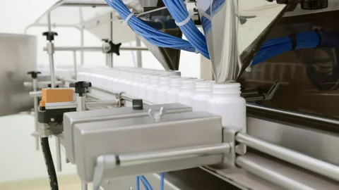 Automatic Capsule Counting and Bottling Machine in Pharmaceutical Production Stock Footage 333159421
